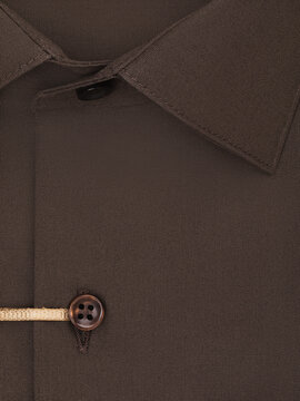 Close-up of a dark brown men's shirt with a collar detail, cotton texture, and button placket