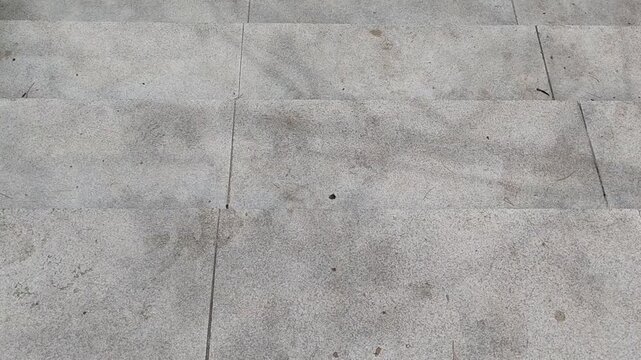 Textured ground surface with contrasting elements and tactile indicators for safety