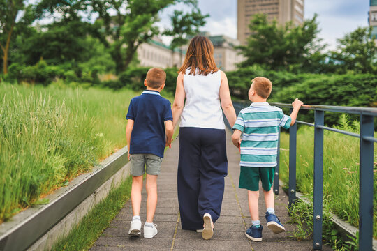 family of three outside people in summer season.