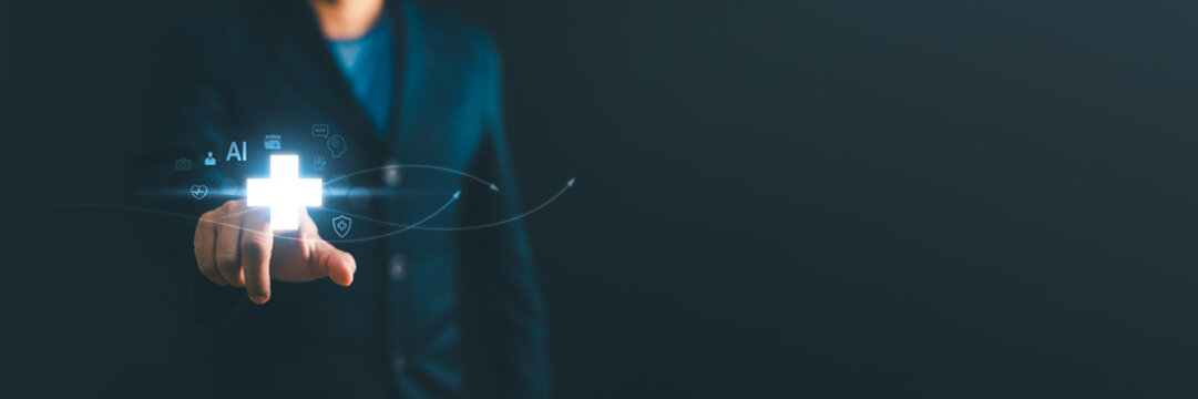 Businessman pointing at a glowing medical cross icon with AI and healthcare technology graphics. Concept of digital health, medical insurance, wellness, and smart hospital innovation