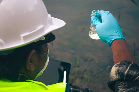 Technicians examining water quality through sample collection to preserve clean and healthy ecosystems.