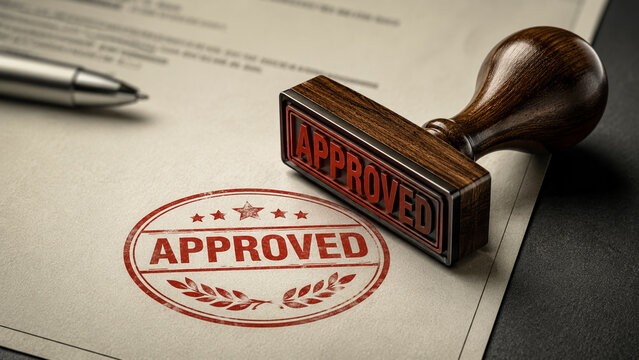 Approved wooden rubber stamp with red ink mark on an official document text.
