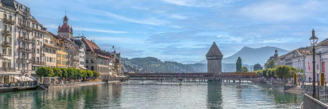 lucerne cityscape with chapel bridge over reuss river under blue sky for european travel branding