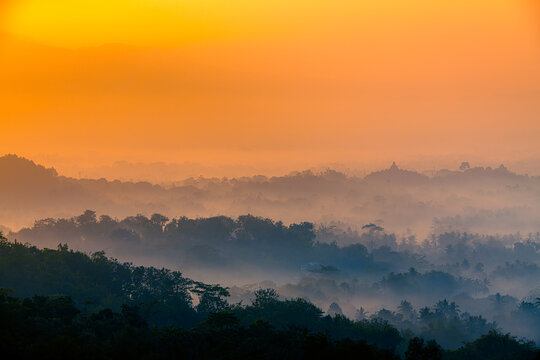 Colorful sunrise background Borobudur Temple, silhouette of Gunung Merapi, Merbabu. View from Punthuk Setumbu. Borobudur, Magelang, Central Java, Indonesia