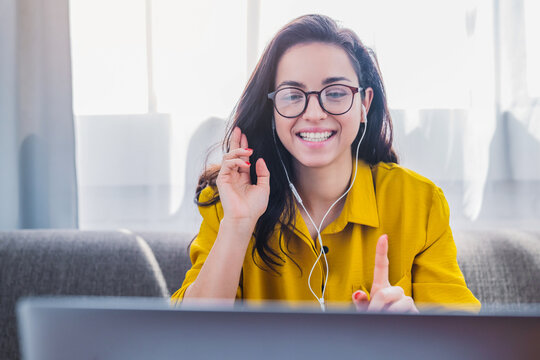 Beautiful young woman using video call on laptop to connect with friends, online tutor or distance education, female chatting online and e-learning concept