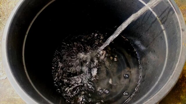 This year&rsquo;s scorching summer has triggered a clean water crisis. Water flows into a black container, creating bubbles and ripples on its surface, presenting a dynamic and refreshing sight of flowing l