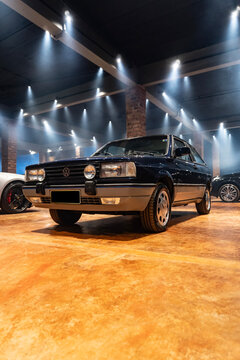 Dark blue Volkswagen Gol GTi front view three quarters in studio, Classic hatchback car in foggy underground cenario