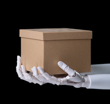 Two white robot hands holding a brown kraft paper box on black background