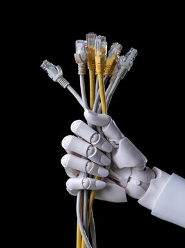 Robot hand holding a bunch of ethernet lan cables on black background.