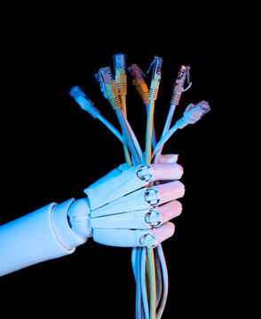 Robot hand holding a bunch of ethernet lan cables on black background.