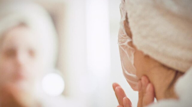 Girl gently smooths moisturizing fabric mask over her face, pressing it to follow every contour for a tight seal. The aloe-vera sheet delivers even hydration, underscoring her daily skin-care routine