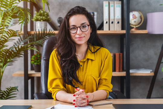 Successful business woman working at office and looking at camera, confident female entrepreneur at workplace, professional career and corporate lifestyle concept