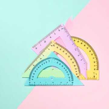 Colorful Geometric Rulers Arranged Artfully on Pastel Background.