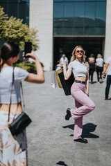 Fototapeta premium Two girls carry shopping bags as one poses and smiles for a photo. Friends enjoy a casual outdoor shopping moment in front of a contemporary storefront.