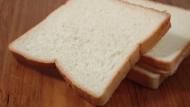 French bread slices on wooden cutting surface
