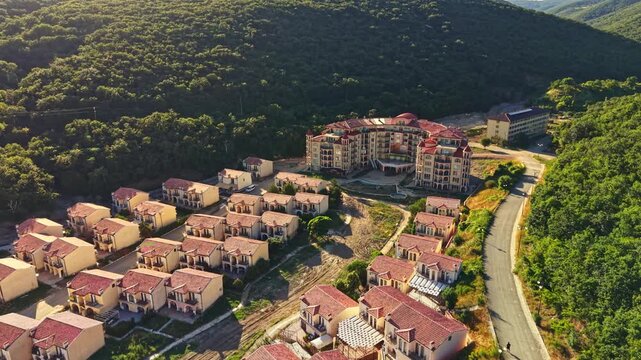 Elenite showcases recovery following a flood. Buildings line the streets with some damage visible. Lush green hills surround the area, indicating nature's resilience.