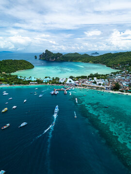 Aerial view of Phi Phi Islands with turquoise waters, boats navigating the bay, and lush green hills in Mueang Krabi District, Krabi, Thailand.