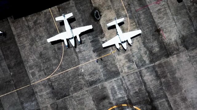 Drone View of Two Small Aircraft on an Open Field