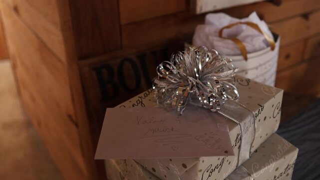 Stacked gift boxes with silver bow and card