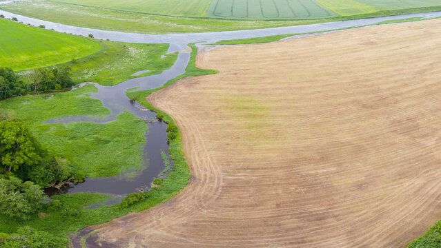 Aerial View of Meandering River and Farmland in Lithuania