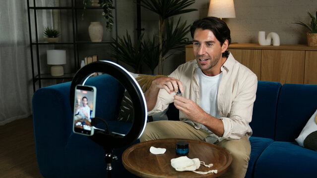 Man creating online content about beauty products at home