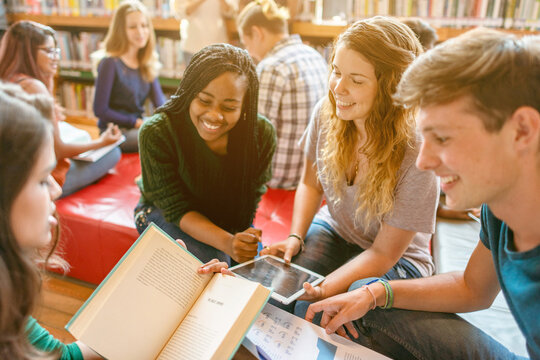 Diverse students collaborating in library