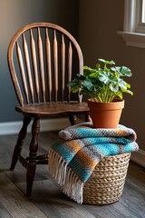 Fototapeta premium Repaired wooden chair with potted plant and folded blanket in cozy home interior