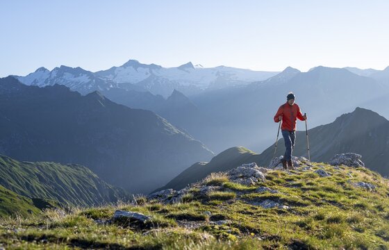 Hiker enjoying the mountain panorama in the morning, Venediger group, behind Dreiherrenkopf, Simonysitze and Gro&szlig;er Geiger, Hohen Tauern, Austria