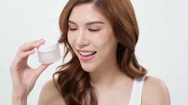Skincare Routine Showcasing a Woman With a Jar of Cream in a Bright Setting