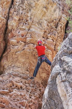Man rock climbing at The Pit in Sandy's Canyon, Flagstaff, Arizona, USA
