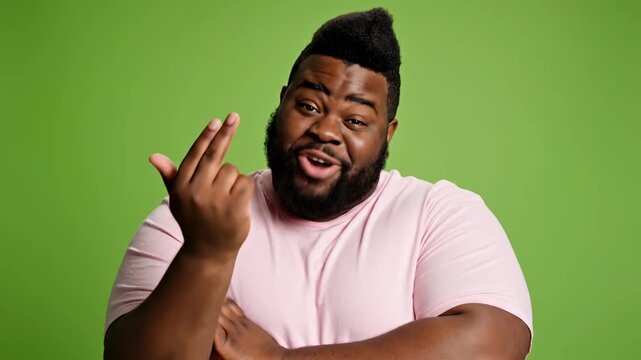 Skeptical Black man with crossed arms on green screen, perfect for custom background replacement.