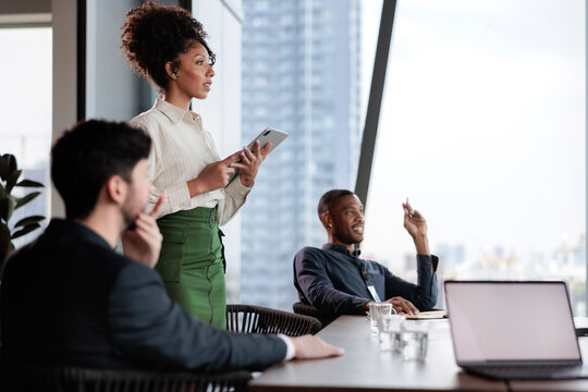 Business meeting in a modern office with city view.