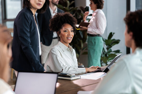 Diverse team collaborates during a meeting.