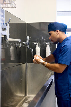 Doctor Sanitizing Hands Before Care