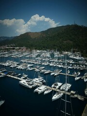 Fototapeta premium Aerial view of white yachts docked at a coastal marina