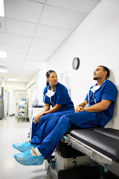 Medical Staff Talk in Hospital Hallway