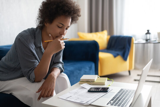 African American woman pondering over taxes