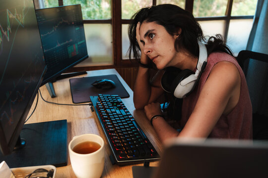woman Trading Stock on Multiple Screens at Home office setup