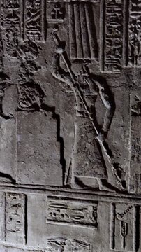 Dendera temple interior sanctuary with illuminated hieroglyphic walls and ritual