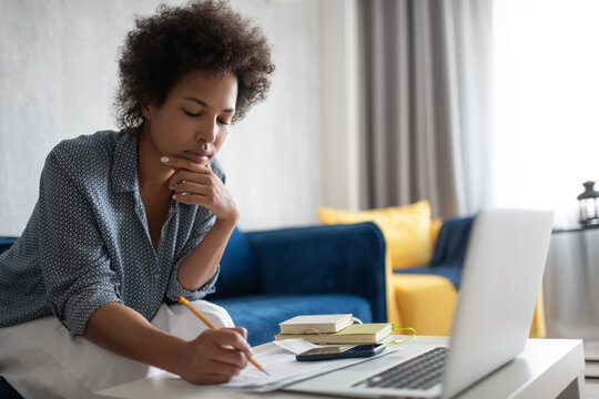 Black woman thinking over tax bills