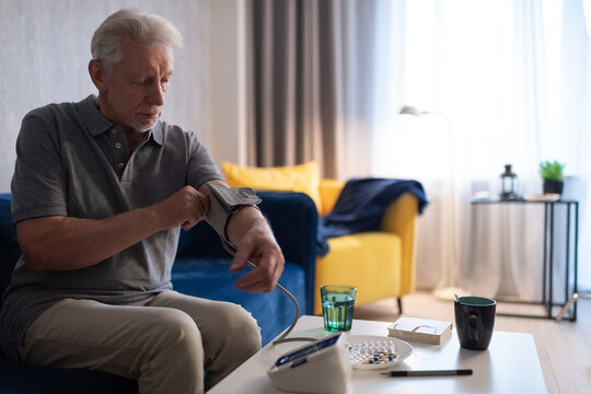 Senior man measuring blood pressure