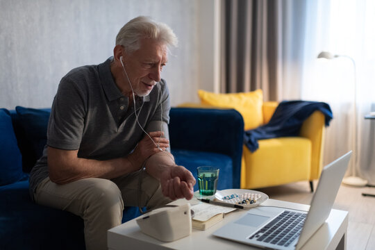 Senior man speaking with online doctor