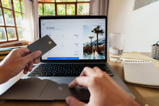  booking Flights Online with Credit Card on Laptop