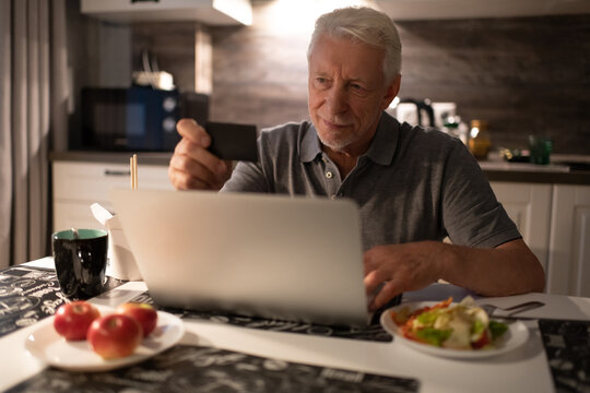 Senior man paying for online purchases