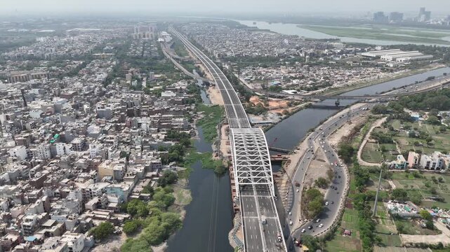 Aerial drone view of Delhi Mumbai Expressway corridor and Delhi Metro near Kalindi Kunj, Delhi India
