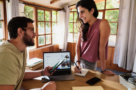  Couple Planning a Trip Together with Laptop and Phone