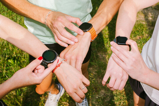 People Showing Smartwatches During Outdoor Activity in the Park