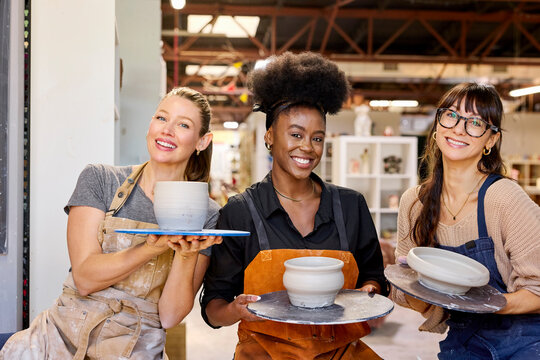 Friends Make Pottery Together in a Studio