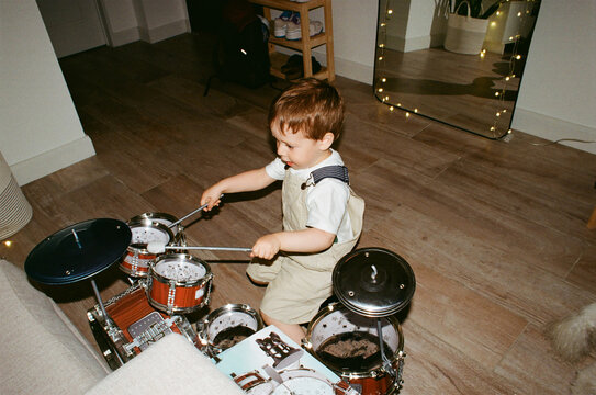 Child playing the drums at home