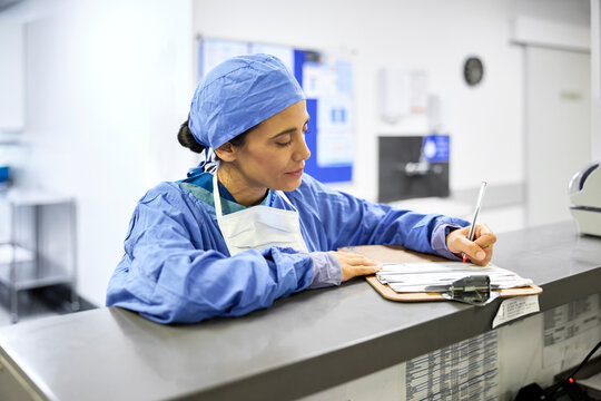 Surgeon writing a report
